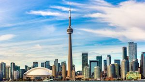 Toronto skyline with CN Tower and Rogers Centre under blue sky
